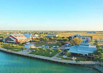 Palm trees and community buildings line the Babcock Ranch lakefront. 